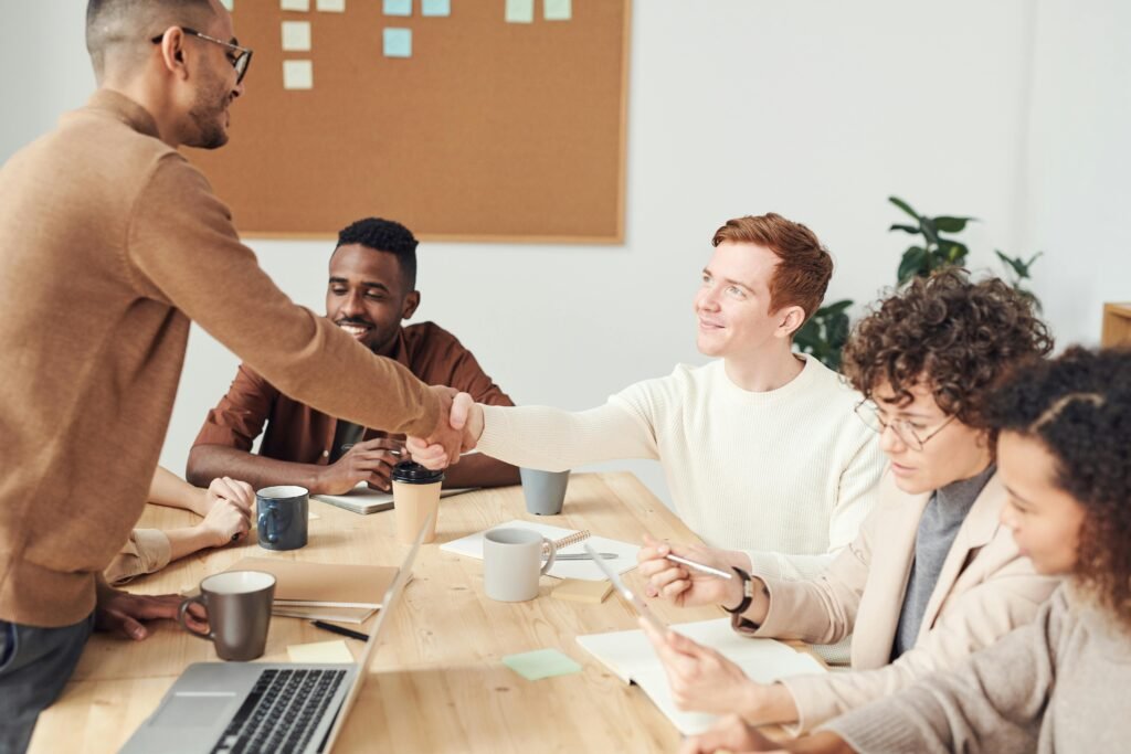A diverse team in a modern office working together on a project, showcasing teamwork and collaboration.